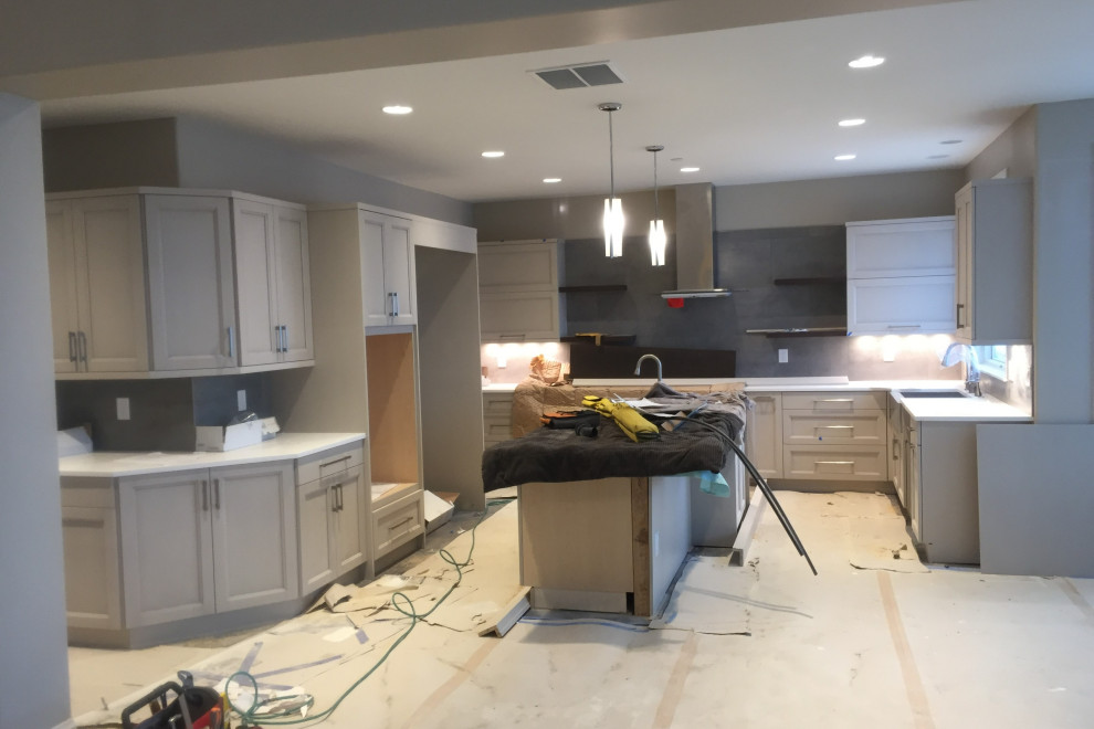 Large l-shaped kitchen photo in Denver with shaker cabinets, gray cabinets and an island