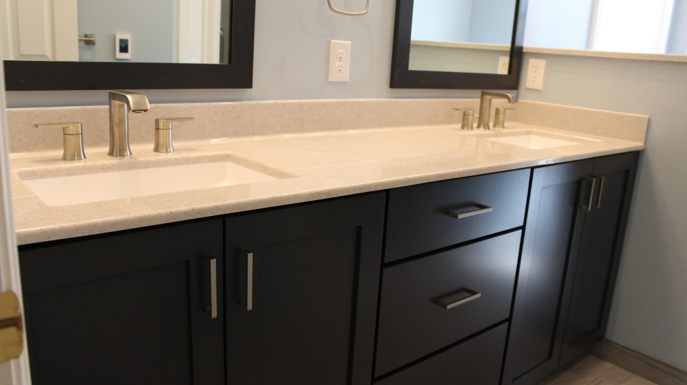 Inspiration for a master bathroom in Other with shaker cabinets, blue cabinets, a drop-in tub, blue walls, ceramic floors, an undermount sink, onyx benchtops, grey floor, beige benchtops, an enclosed toilet, a double vanity and a built-in vanity.