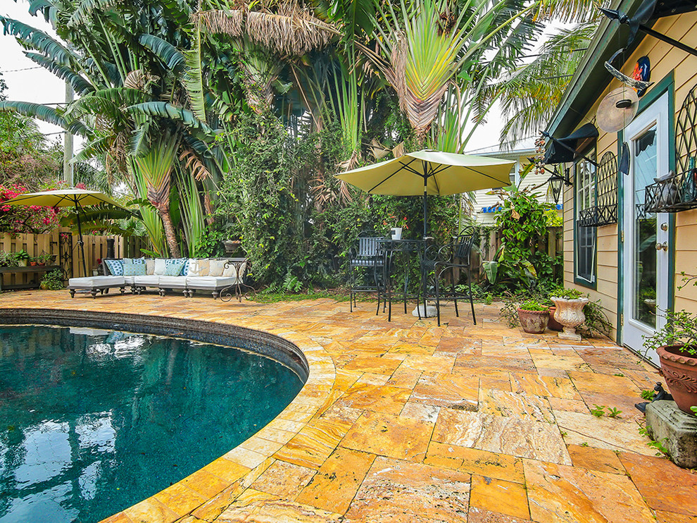 Inspiration for a mid-sized eclectic backyard kidney-shaped lap pool in Miami.