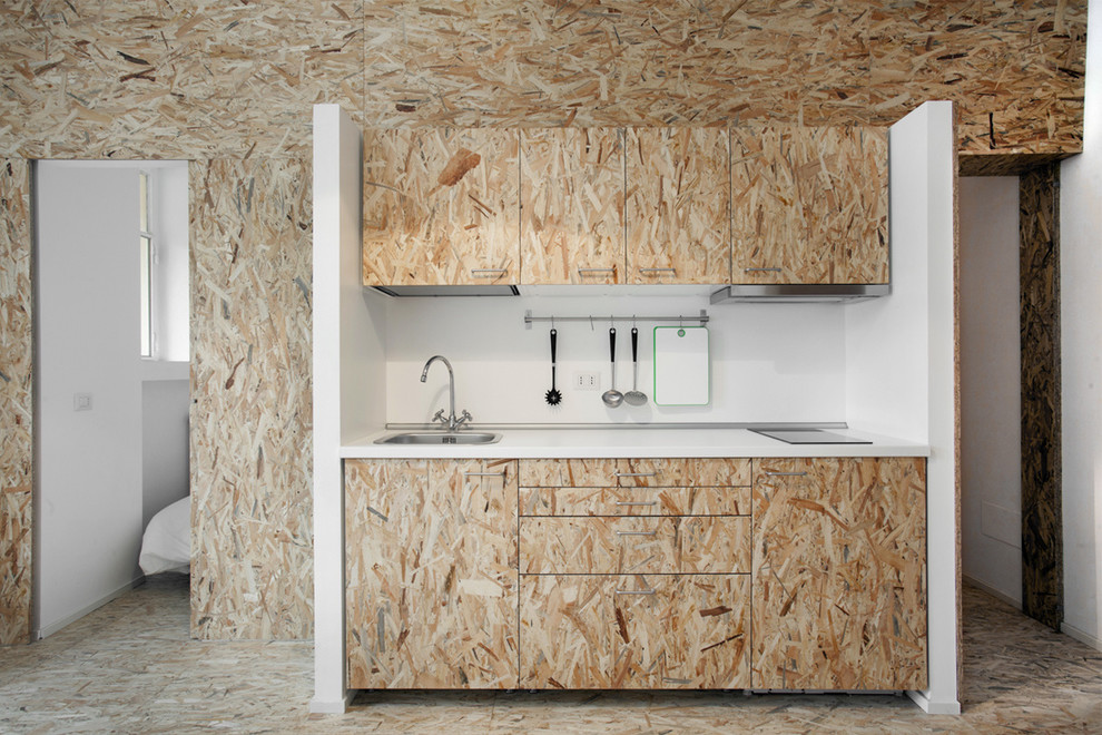 This is an example of a small contemporary kitchen in Milan with a drop-in sink and flat-panel cabinets.