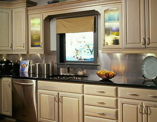 Inspiration for a mid-sized eat-in kitchen remodel with a drop-in sink, distressed cabinets, granite countertops, beige backsplash and stainless steel appliances