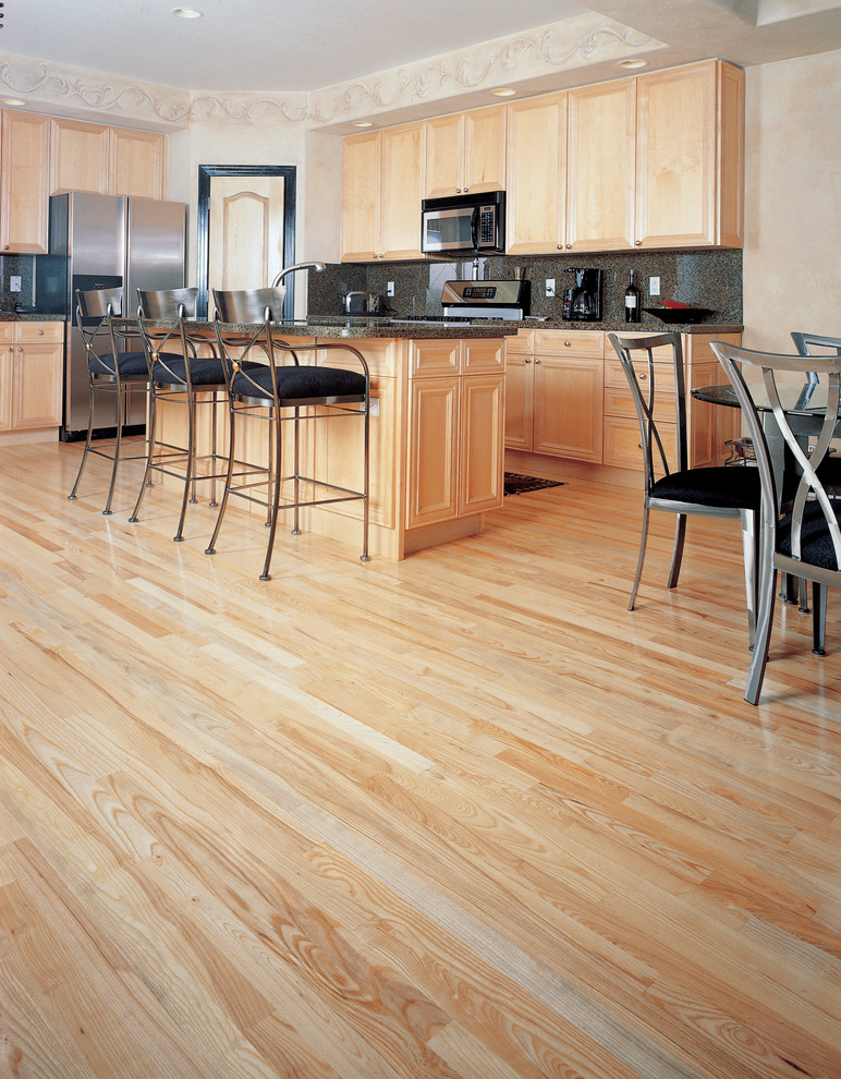 Open concept kitchen - large transitional l-shaped medium tone wood floor and brown floor open concept kitchen idea in DC Metro with an undermount sink, recessed-panel cabinets, medium tone wood cabinets, granite countertops, stainless steel appliances and an island