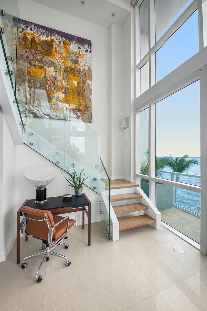 This is an example of a contemporary wood l-shaped staircase in Miami with open risers.