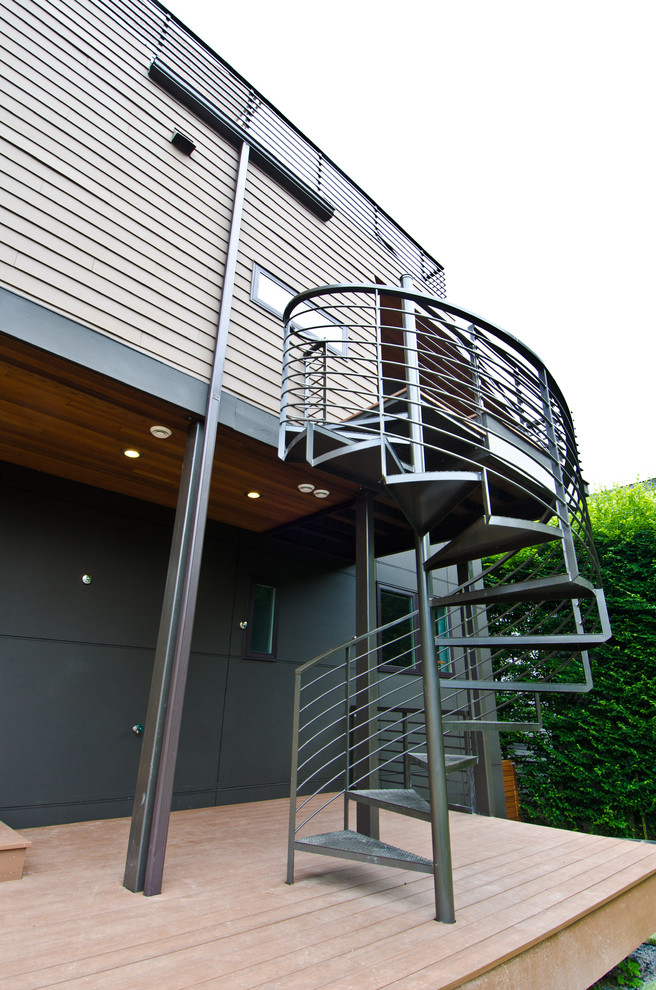 Large modern three-storey black exterior in Seattle with wood siding and a shed roof.