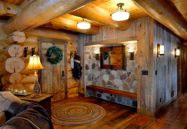Inspiration for a mid-sized rustic dark wood floor foyer remodel in Minneapolis with brown walls and a medium wood front door