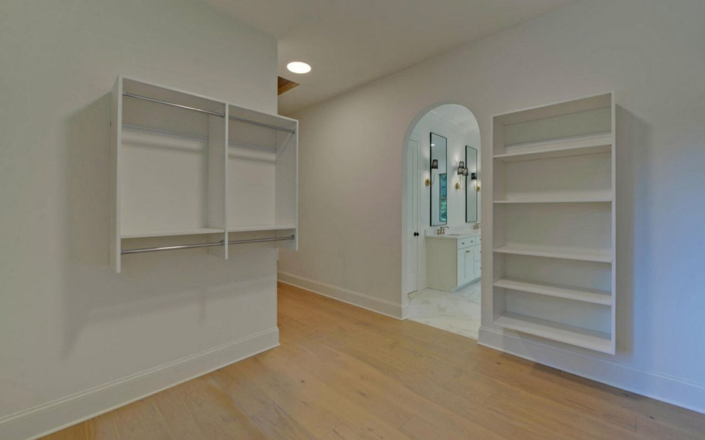 Photo of a classic wardrobe in Atlanta with flat-panel cabinets.
