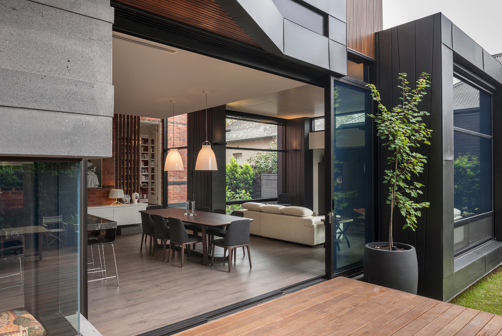 This is an example of a contemporary open plan dining in Melbourne with light hardwood floors.