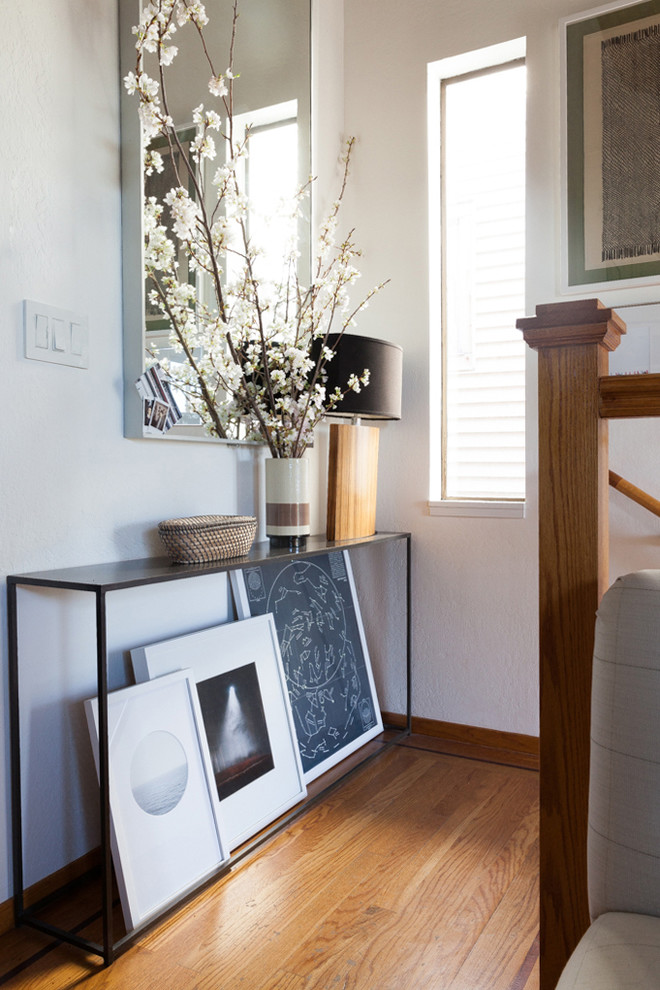 Inspiration for a small eclectic entryway in San Francisco with white walls, medium hardwood floors and brown floor.