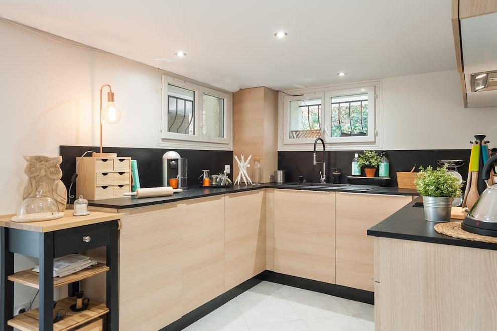 Design ideas for a mid-sized contemporary u-shaped open plan kitchen in Other with a single-bowl sink, beaded inset cabinets, light wood cabinets, laminate benchtops, black splashback, slate splashback, panelled appliances, ceramic floors, no island and white floor.
