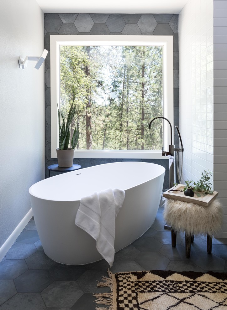 Inspiration for a large modern master bathroom in Sacramento with flat-panel cabinets, dark wood cabinets, a freestanding tub, a one-piece toilet, gray tile, slate, white walls, slate floors, an undermount sink, engineered quartz benchtops, grey floor and a hinged shower door.