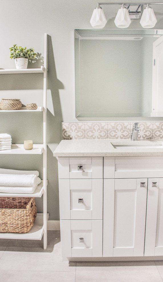 Inspiration for a transitional gray tile and porcelain tile porcelain tile, gray floor and single-sink bathroom remodel in Calgary with shaker cabinets, white cabinets, a two-piece toilet, gray walls, an undermount sink, quartz countertops, white countertops and a built-in vanity