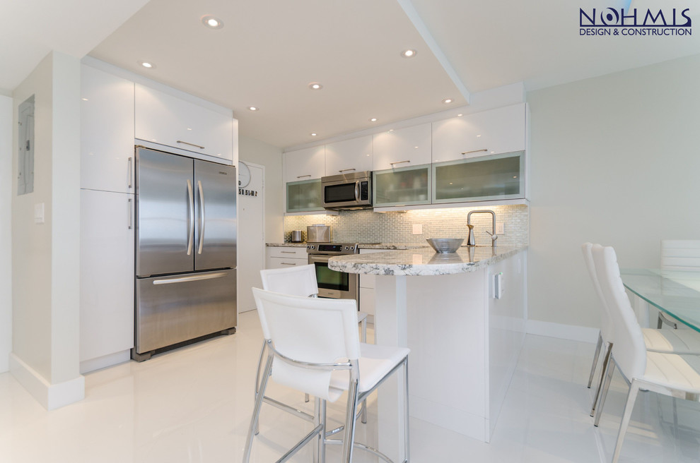 Example of a mid-sized trendy galley marble floor eat-in kitchen design in Miami with a double-bowl sink, recessed-panel cabinets, white cabinets, granite countertops, beige backsplash, mosaic tile backsplash, stainless steel appliances and an island