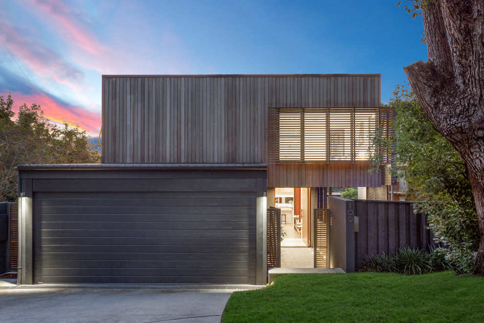 Photo of a contemporary two-storey beige house exterior in Brisbane with wood siding and a flat roof.