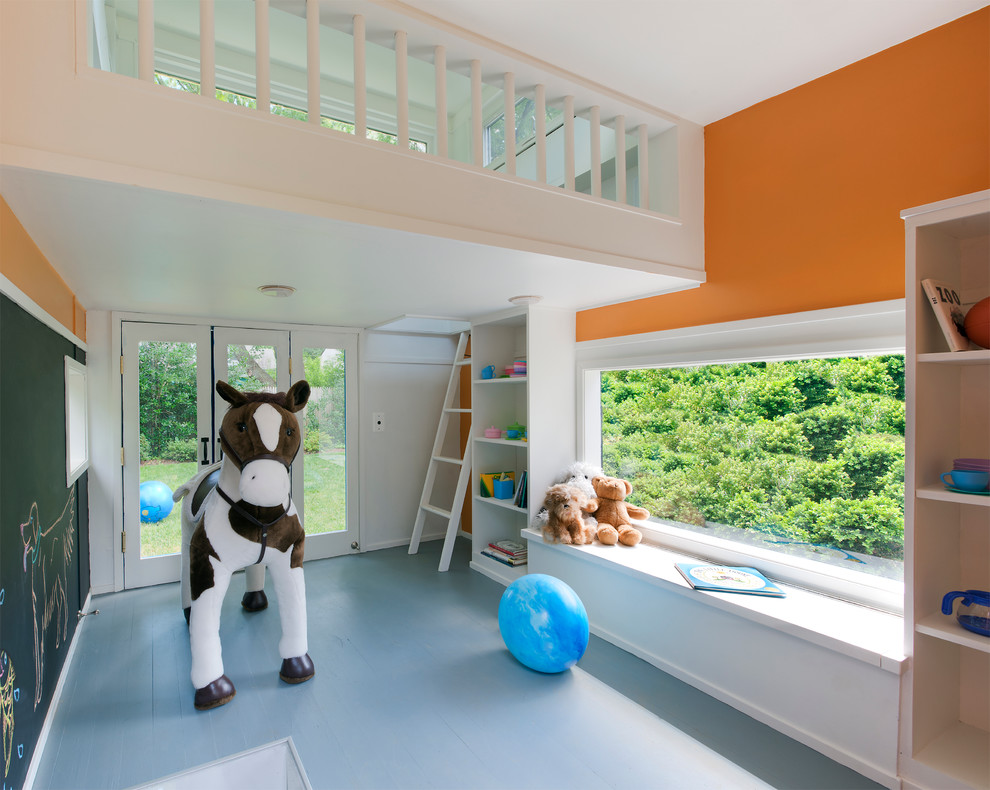 Photo of a modern gender-neutral kids' playroom for kids 4-10 years old in DC Metro with orange walls, painted wood floors and blue floor.