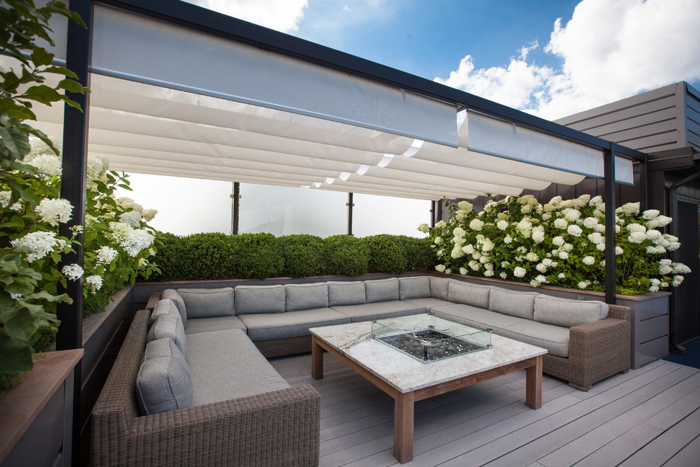 Inspiration for a mid-sized contemporary rooftop deck in Chicago with a fire feature and a pergola.
