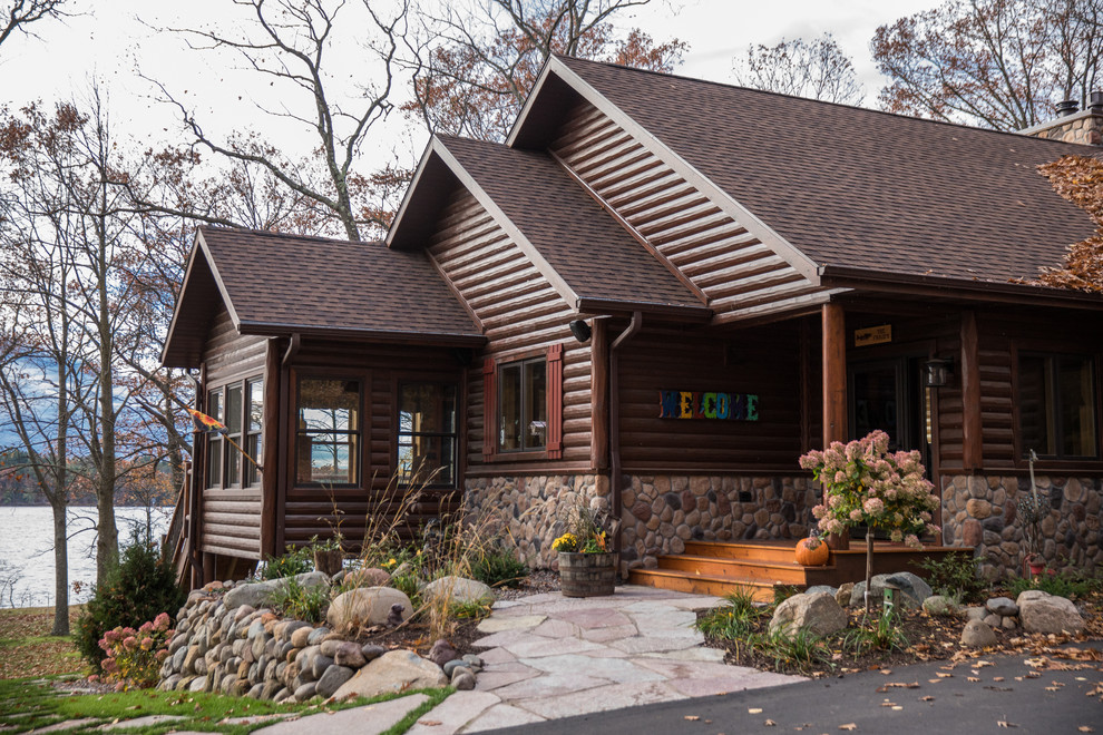 Front door - rustic medium tone wood floor and brown floor front door idea with brown walls