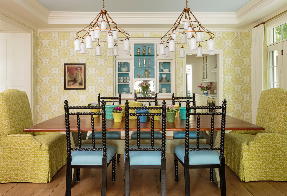 Photo of a country separate dining room in Los Angeles with multi-coloured walls, medium hardwood floors and brown floor.