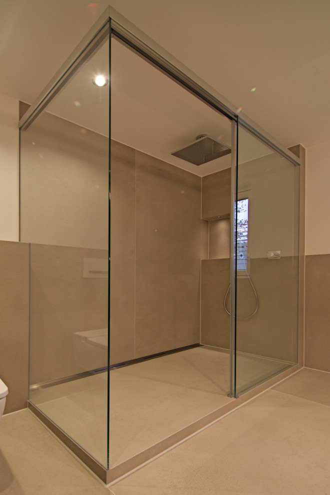 Photo of a large modern shower room bathroom in Munich with flat-panel cabinets, medium wood cabinets, a corner shower, a wall mounted toilet, beige tiles, stone tiles, white walls, a wall-mounted sink, solid surface worktops, beige floors, a sliding door, white worktops, double sinks and a floating vanity unit.