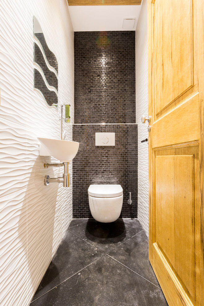 Inspiration for a small traditional powder room in Marseille with a wall-mount toilet, white tile, gray tile, ceramic tile, white walls, ceramic floors, a wall-mount sink and grey floor.