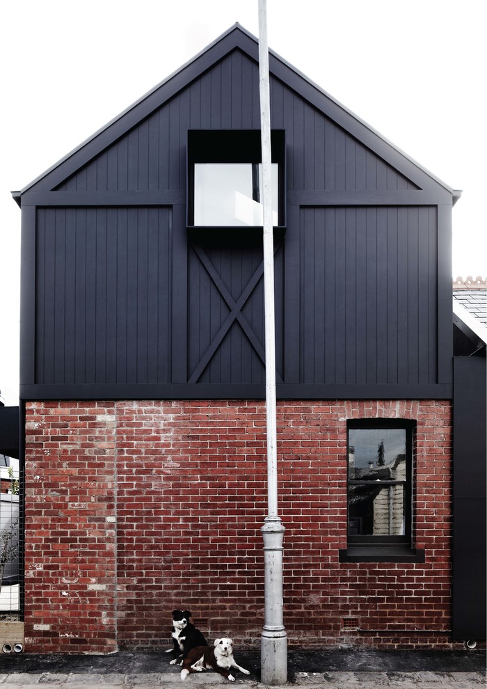 Mid-sized contemporary two-storey black exterior in Melbourne with mixed siding and a gable roof.