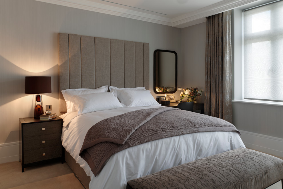 Contemporary master bedroom in London with grey walls and carpet.