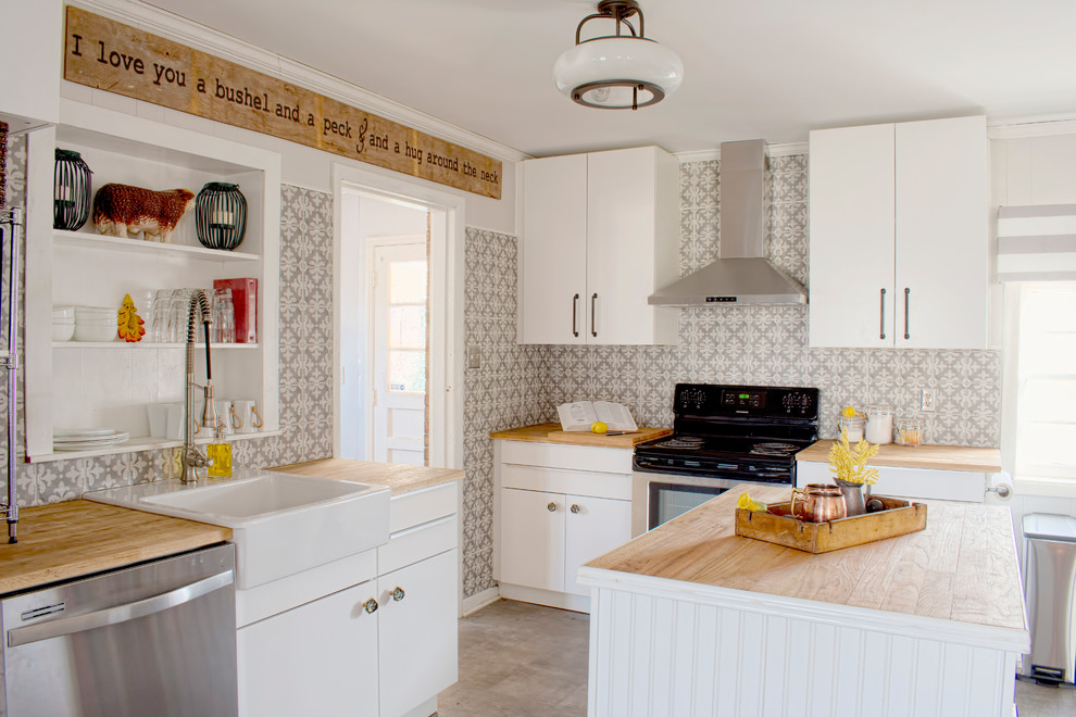 Design ideas for a mid-sized country l-shaped open plan kitchen in Raleigh with a farmhouse sink, flat-panel cabinets, white cabinets, wood benchtops, grey splashback, porcelain splashback, stainless steel appliances, vinyl floors and with island.