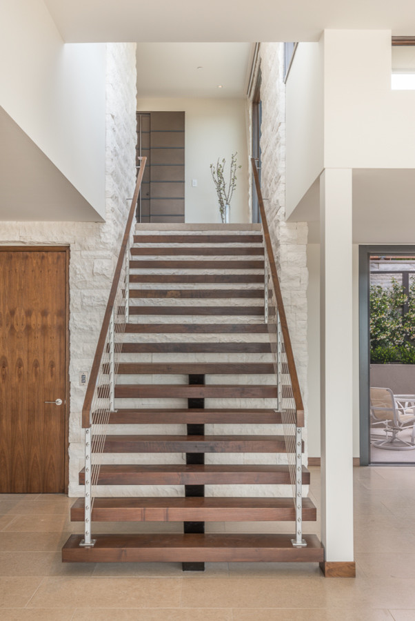 Design ideas for a modern wood floating staircase in San Francisco with open risers.