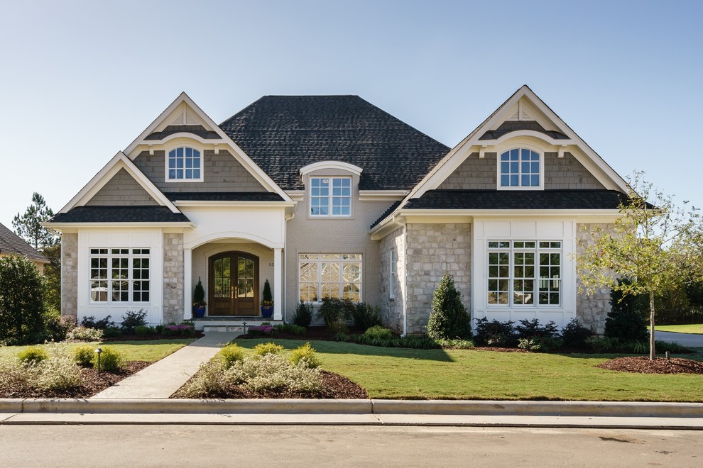 Inspiration for a traditional two-storey beige exterior in Raleigh with mixed siding and a hip roof.