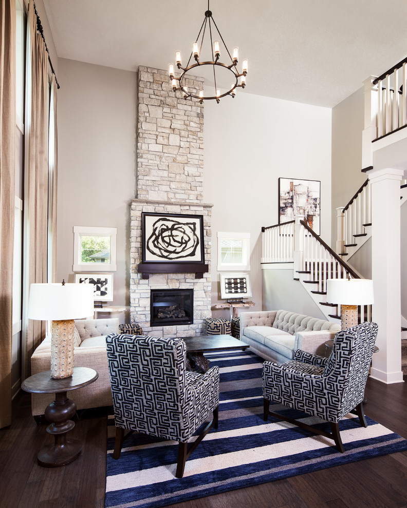 Inspiration for a traditional formal open concept living room in Omaha with beige walls, dark hardwood floors, a standard fireplace, a stone fireplace surround and no tv.