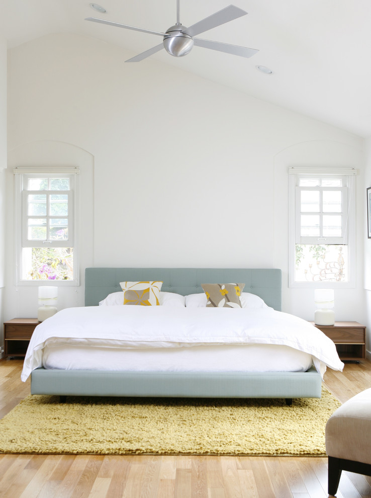 Inspiration for a modern master bedroom in Los Angeles with white walls and light hardwood floors.