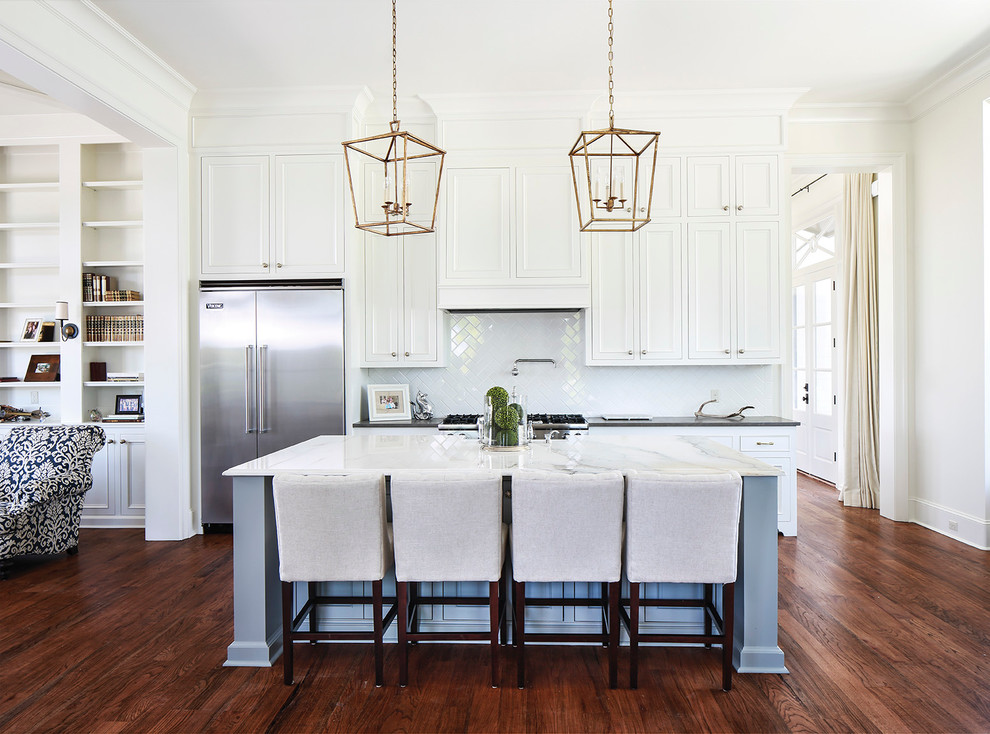 Inspiration for a traditional open plan kitchen in Nashville with recessed-panel cabinets, white cabinets, white splashback, subway tile splashback and stainless steel appliances.