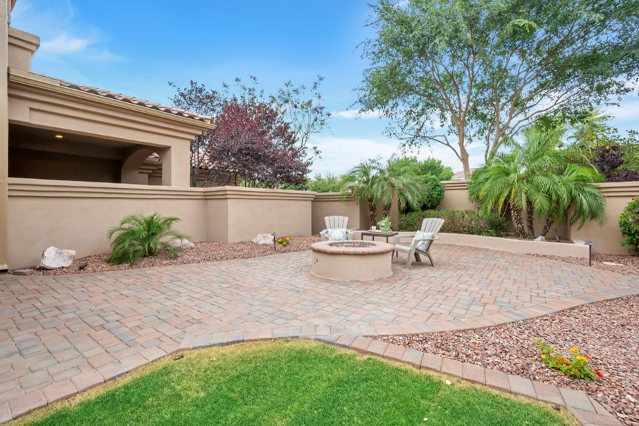 Patio - large transitional backyard concrete paver patio idea in Phoenix with a fire pit and a pergola