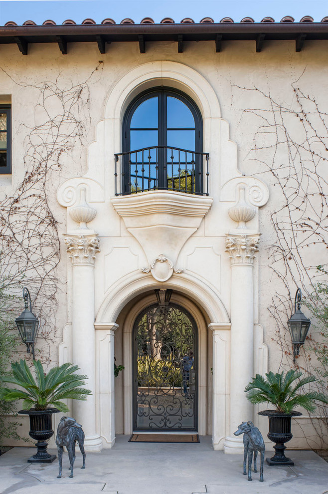 This is an example of an expansive mediterranean front door in Los Angeles with a single front door and a glass front door.