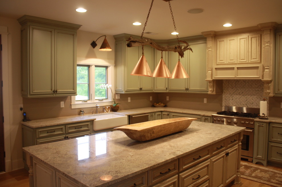 Inspiration for a large rustic u-shaped light wood floor eat-in kitchen remodel with a farmhouse sink, raised-panel cabinets, green cabinets, granite countertops, gray backsplash, ceramic backsplash, stainless steel appliances and an island