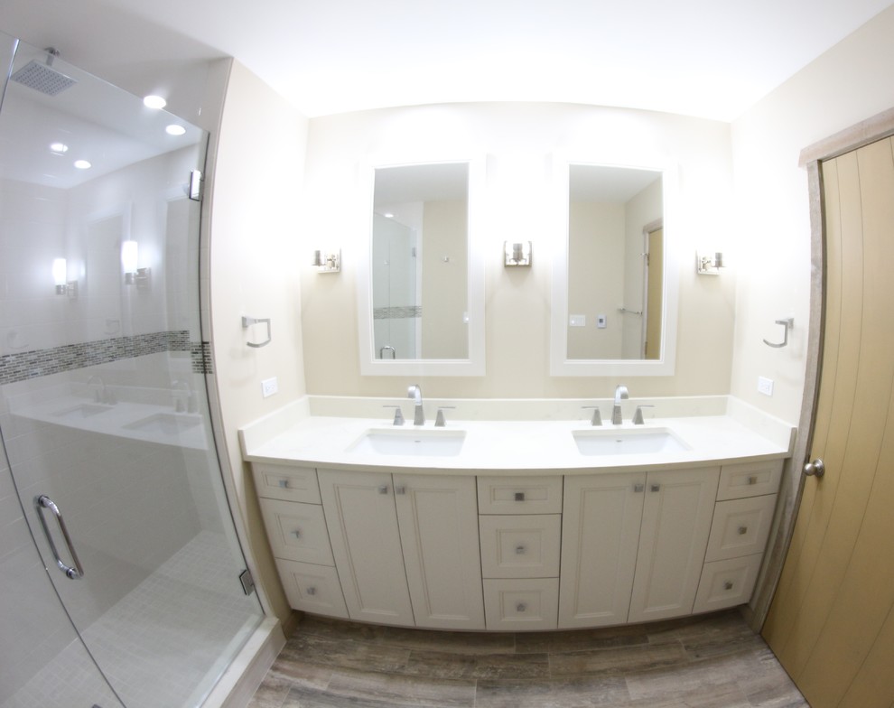 Alcove shower - mid-sized rustic master ceramic tile porcelain tile alcove shower idea in Chicago with recessed-panel cabinets, white cabinets, a two-piece toilet, beige walls, an undermount sink and quartz countertops