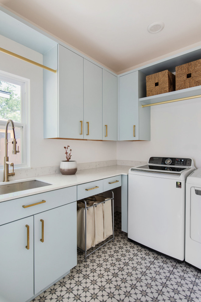 Inspiration for a contemporary laundry room in Austin with an undermount sink, flat-panel cabinets, marble benchtops, white splashback, marble splashback, porcelain floors, a side-by-side washer and dryer and white benchtop.