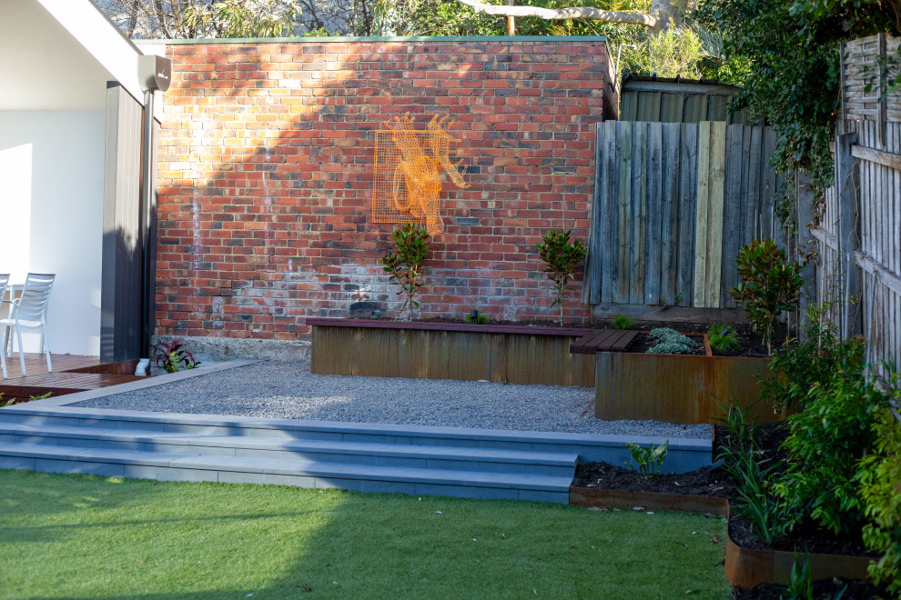 Design ideas for a mid-sized contemporary backyard full sun xeriscape in Melbourne with with raised garden bed and mulch.