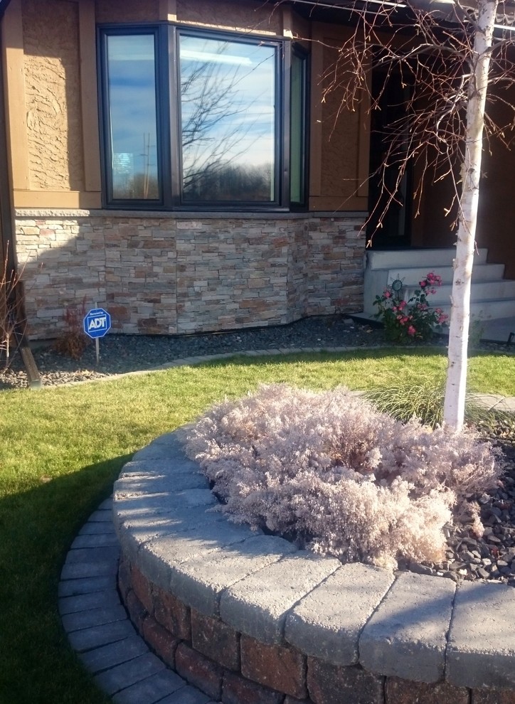 Inspiration for a small traditional one-storey brown exterior in Calgary with stone veneer.