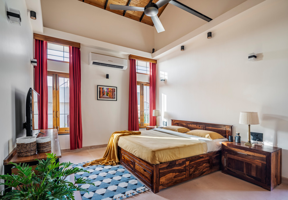 Inspiration for a large contemporary master bedroom in Chennai with white walls, limestone floors, no fireplace, a wood fireplace surround, yellow floor and vaulted.