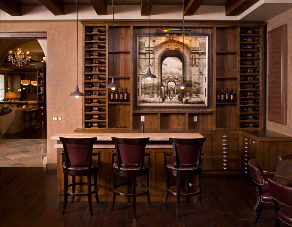 Design ideas for a large mediterranean l-shaped seated home bar in Phoenix with an undermount sink, flat-panel cabinets, medium wood cabinets, wood benchtops, dark hardwood floors and brown floor.