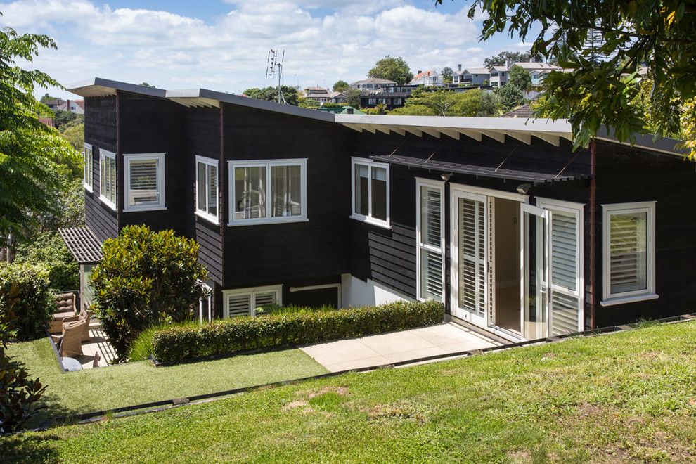 Photo of a large arts and crafts home design in Auckland.