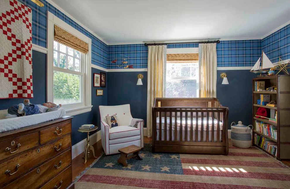 Design ideas for a traditional nursery for boys in Boston with blue walls and medium hardwood floors.