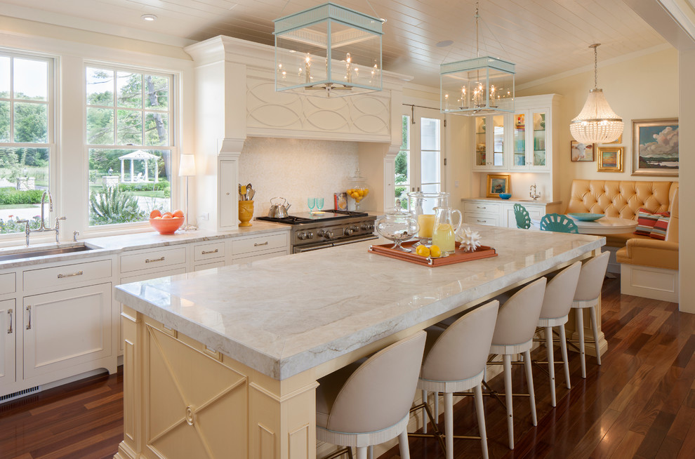 Design ideas for a traditional eat-in kitchen in Grand Rapids with an undermount sink, beaded inset cabinets, white cabinets, white splashback, stainless steel appliances, medium hardwood floors and with island.
