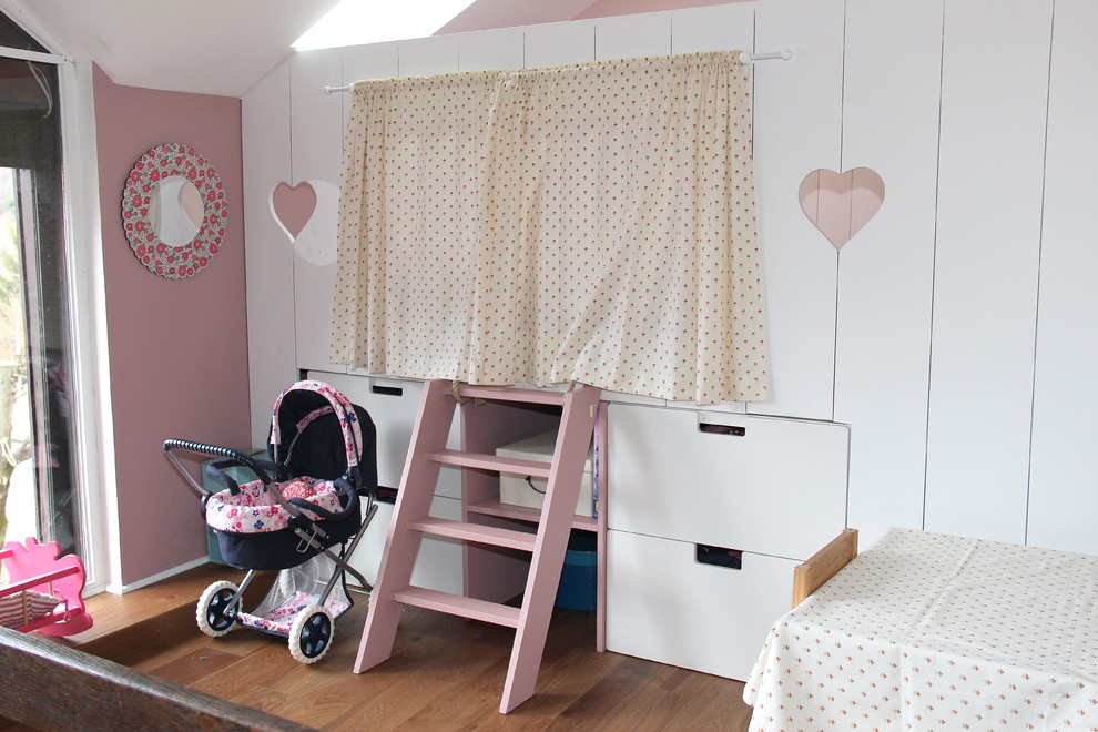This is an example of a large country kids' room in Grenoble with blue walls and dark hardwood floors.