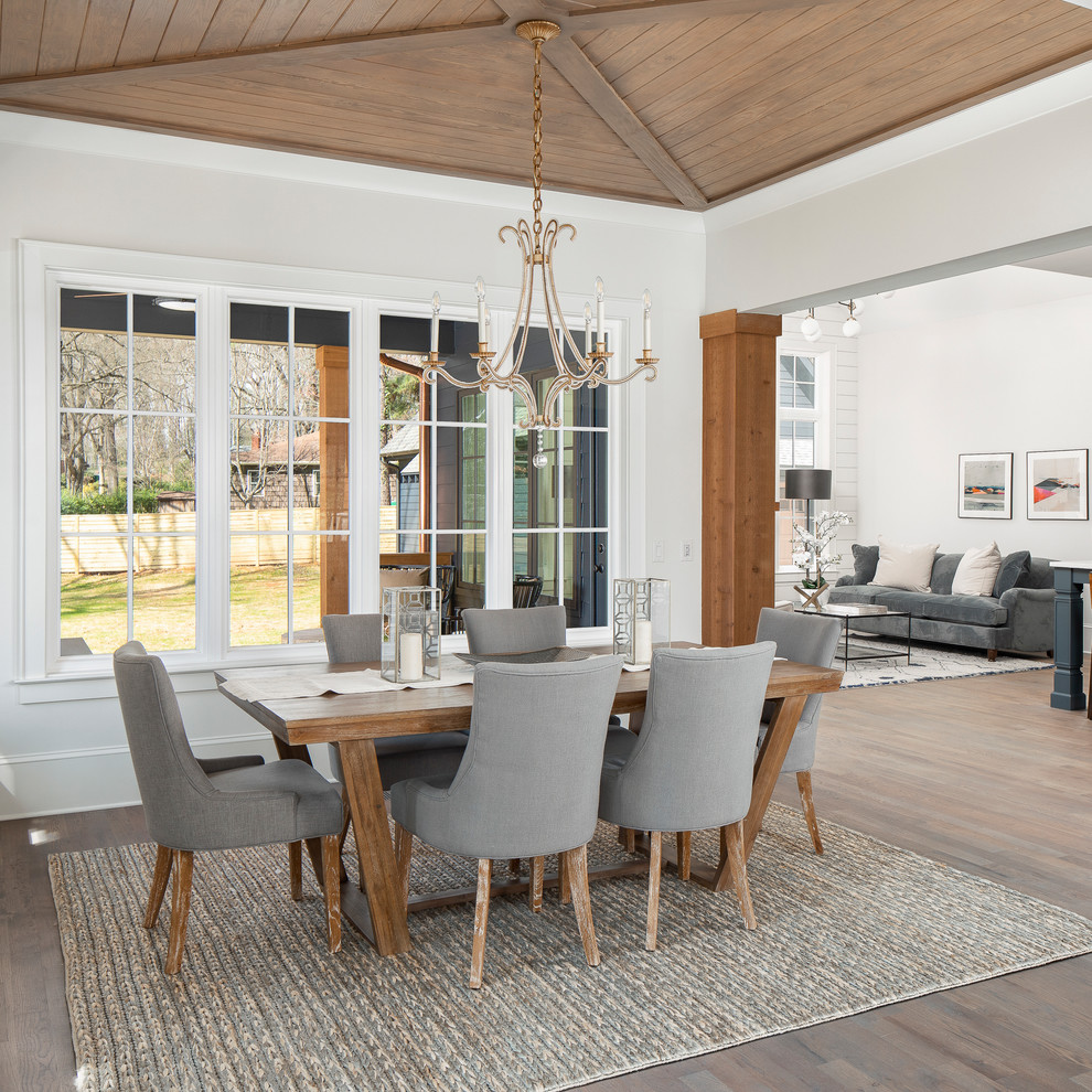 Photo of a large country open plan dining in Charlotte with brown floor, grey walls and dark hardwood floors.