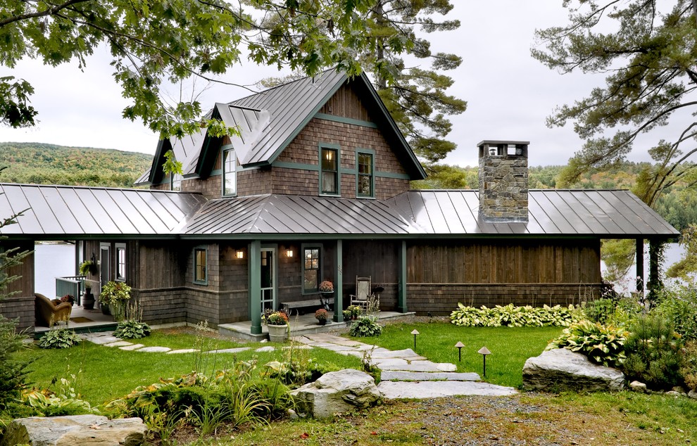 Design ideas for a country exterior in Burlington with wood siding and a metal roof.
