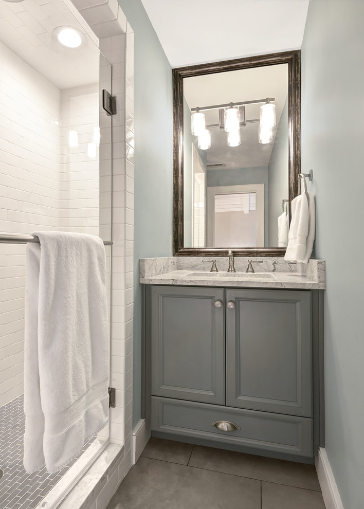Inspiration for a small transitional kids bathroom in Charleston with an undermount sink, flat-panel cabinets, white cabinets, marble benchtops, an alcove shower, a two-piece toilet, gray tile, ceramic tile, white walls and ceramic floors.