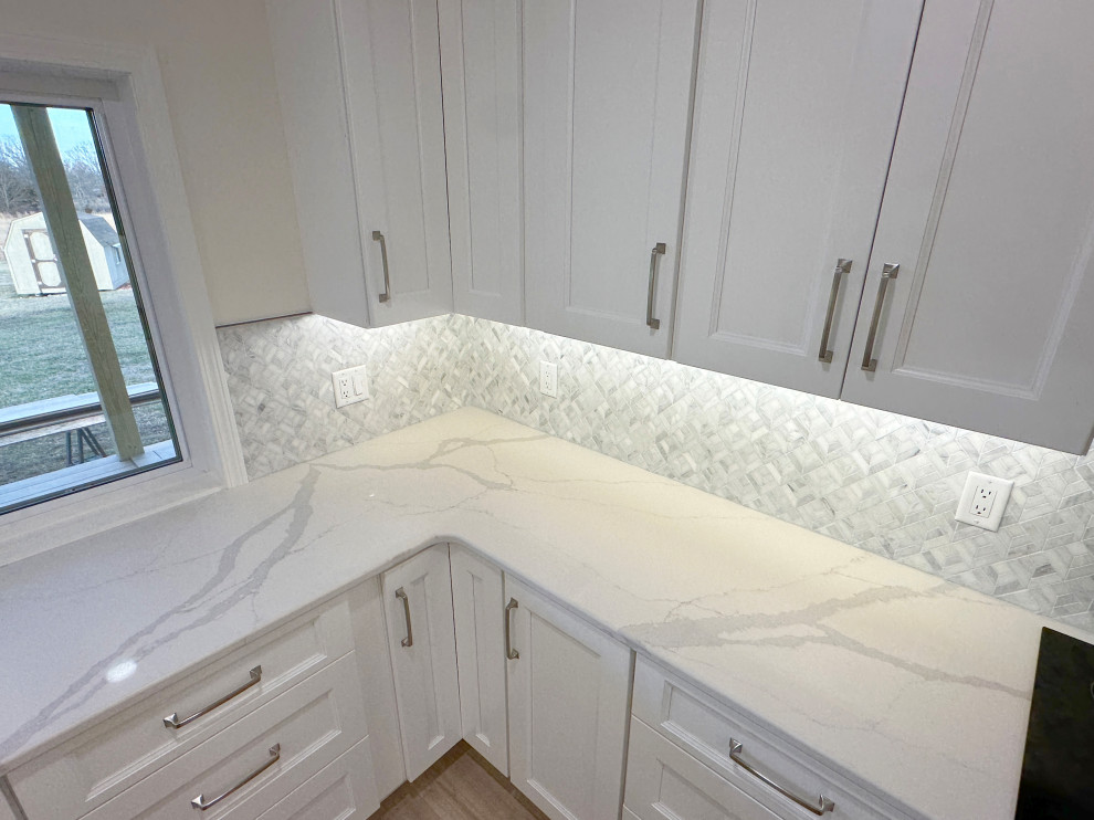 Inspiration for a large transitional kitchen remodel with gray backsplash, marble backsplash and white countertops
