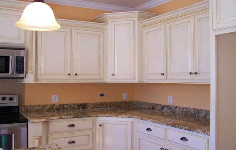 Example of a large kitchen design with recessed-panel cabinets, white cabinets, granite countertops and stainless steel appliances