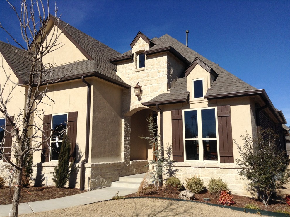 Photo of a large traditional two-storey beige exterior in Other.